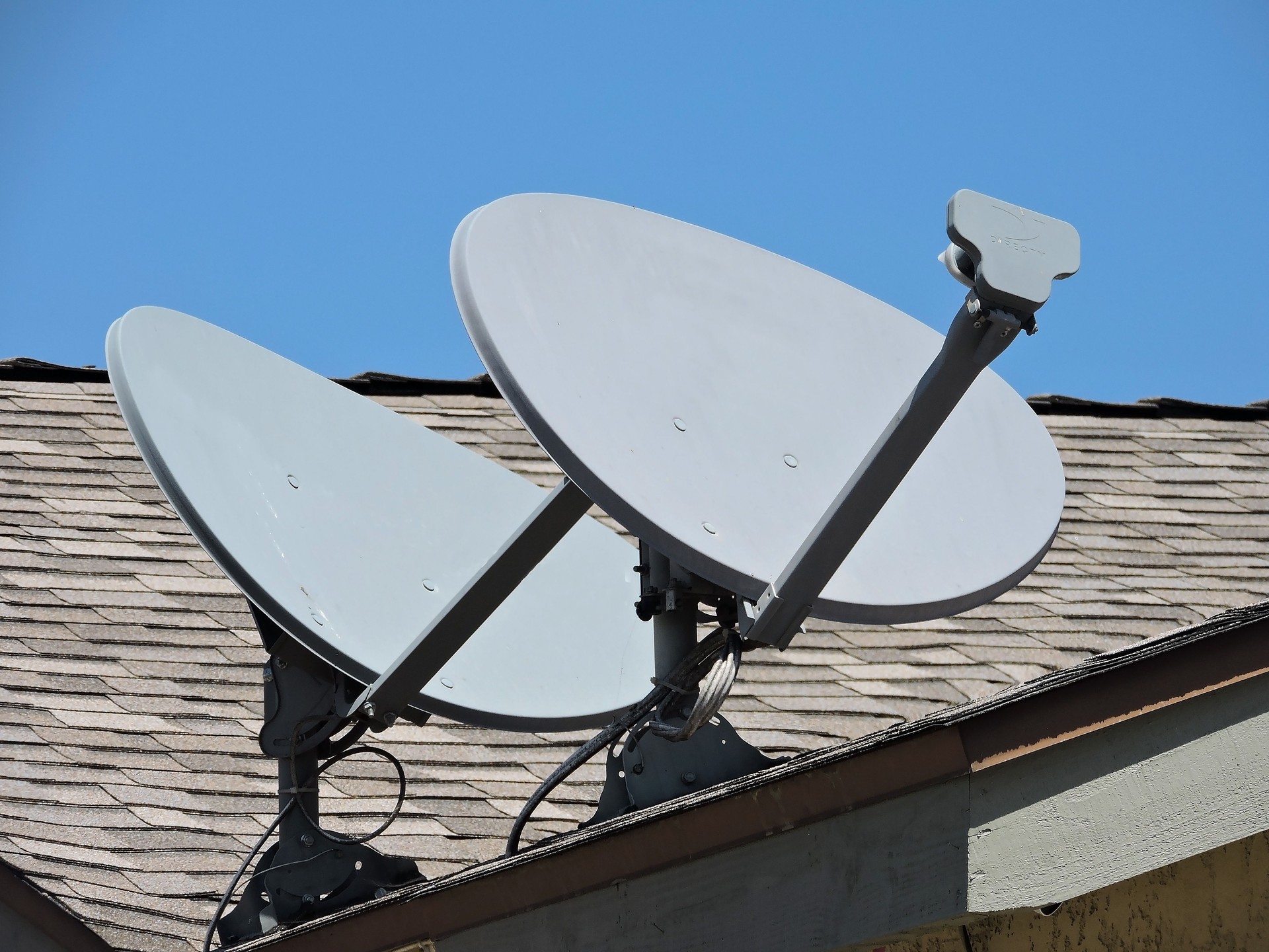 Two Satellite Dishes On  A Roof